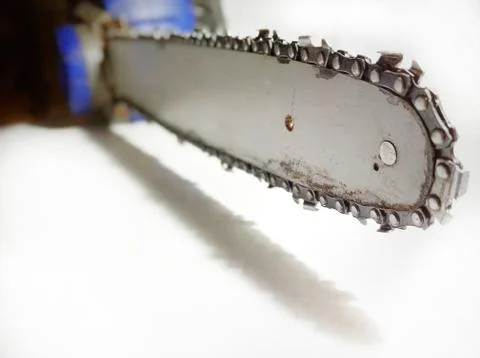  Closeup view of a chainsaw bar and cutting chain. Dirty blade of a chainsaw. Bl Stock Photos