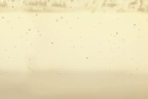 Closeup view of champagne with bubbles as background Stock Photos