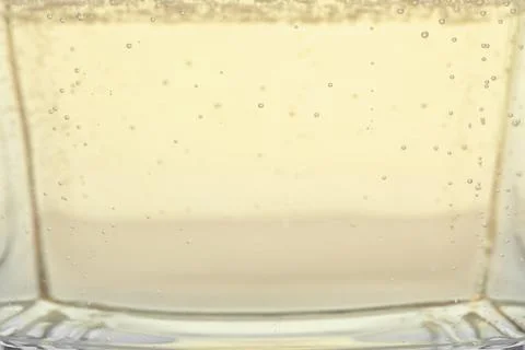 Closeup view of champagne with bubbles as background Stock Photos