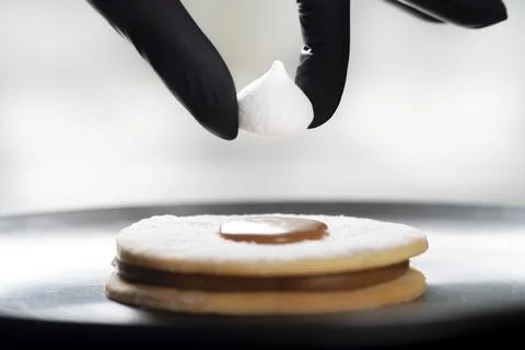 Closeup view of the chef decorating the cake Stock Photos
