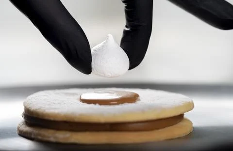 Closeup view of the chef decorating the cake Stock Photos