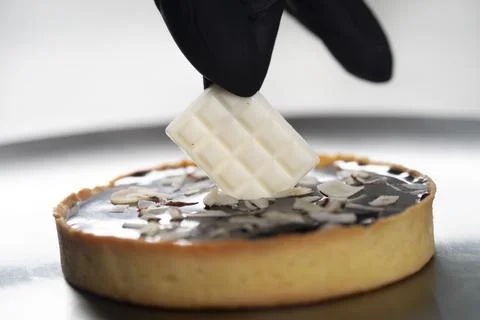 Closeup view of the chef decorating the cake Stock Photos