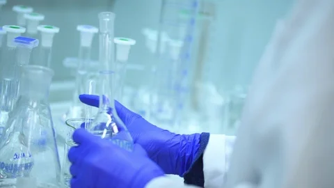 Closeup view of chemist working with chemical solution, standing in Stockbeeldmateriaal 130169933
