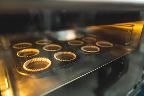 Closeup view of chocolate muffins baking in an oven, sweets and dessers concept Stock Photos