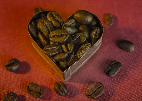 Closeup view of coffee beans inside a heart shape - romantic theme Stock Photos
