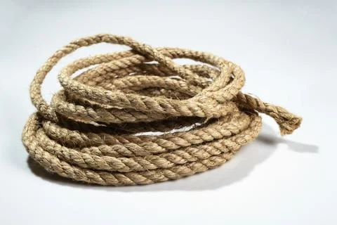Closeup view of coiled ropes string isolated over a white background Foto stock