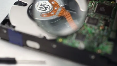 Closeup view of a computer hard disc with magnifying glass. Video stock 91868718