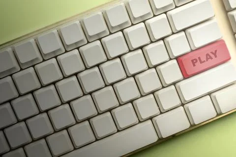 Closeup view of a computer keyboard with a red button that says "Play". Gre.. Stock Photos