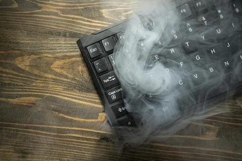 Closeup view of a computer keyboard with white smoke Fotos de archivo