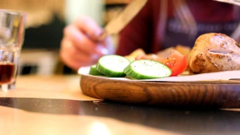 Closeup view of cooked tasty grilled meat with sliced vegetables on wooden round 스톡 동영상 117675301