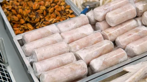Closeup view of counter of fresh and frozen sea food in a store in slow motion Stock Footage 119837330
