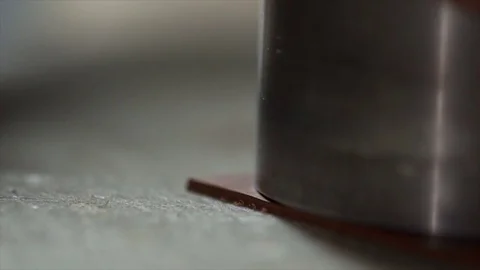 Closeup view of craftsman's hands cutting a round piece of leather on the table Stock Footage 71503367