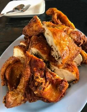 Closeup view of Crispy Herbal Deep Fried Chicken Breast on blue plate Stock Photos