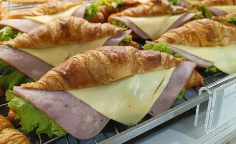 Closeup view. Croissant with ham and cheese on tray. Foto stock