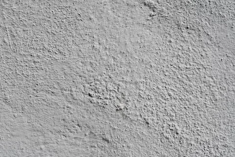 Closeup view of dark gray granular surface with fine rough texture, scattered Stock Photos