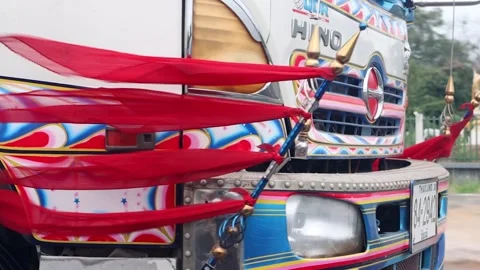 Closeup view of decorative flags fluttering on the front of a truck Stock Footage 272703128