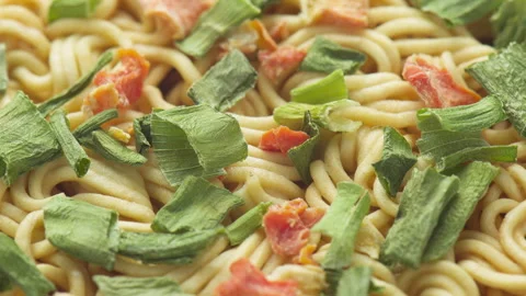 Closeup view of dehydrated vegetables on dried instant noodles Stock Footage 322875782
