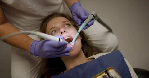 Closeup view of dentist performing procedure on patient in dental clinic during Video stock 321990241