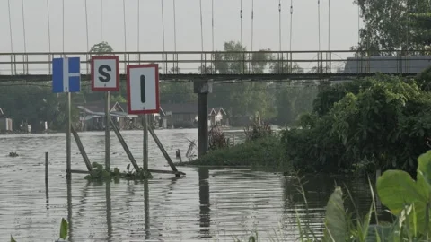 Closeup view, different inland waterways signs near hanging bridge of the river Stock Footage 135956308