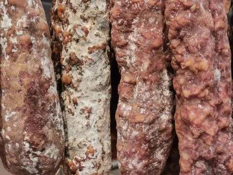 Closeup view of different varieties of dry sausages and spanish chorizos on a Stock Photos