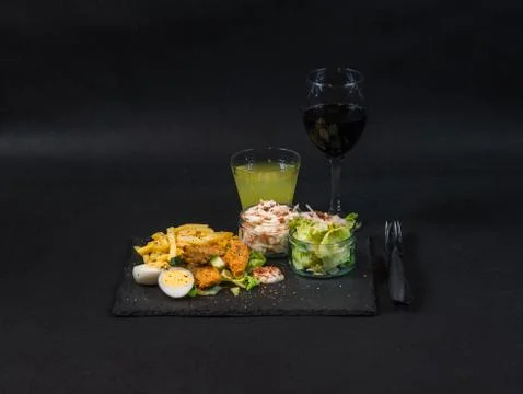 Closeup view of a dish consisting of chicken breast breaded, French fries Stock Photos