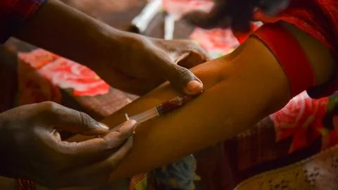 Closeup view of doctor's hands taking a blood sample from pregnant lady. swab Stock Photos