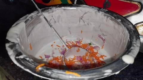 Closeup view of dosa batter with chopped carrots and onions in bowl Stock Footage 337038095