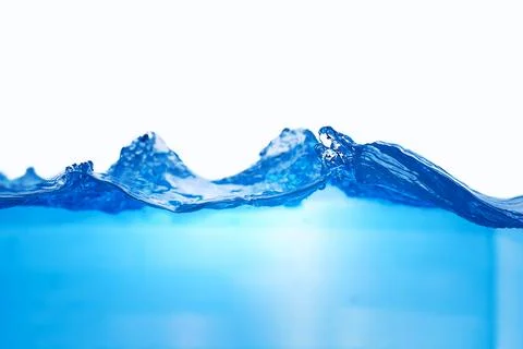 Closeup view of dynamic flowing blue water waves on white background. Liqui.. Stock Photos