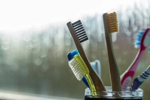 Closeup view of eco-friendly bamboo toothbrush next to window in bathroom Foto stock