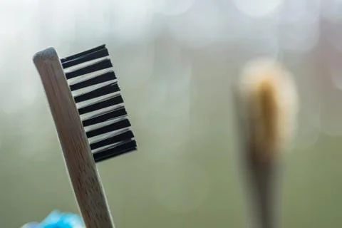 Closeup view of eco-friendly bamboo toothbrush next to window in bathroom Stock-Fotos