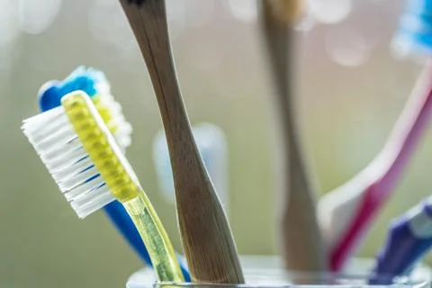 Closeup view of eco-friendly bamboo toothbrush next to window in bathroom Stock-Fotos