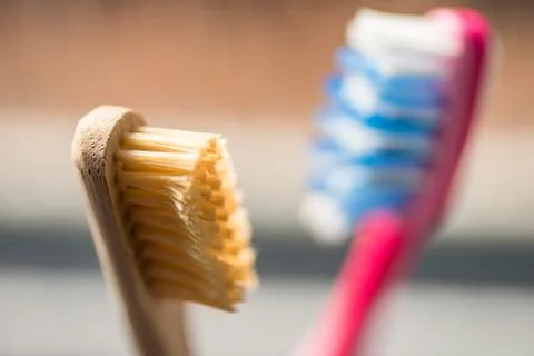 Closeup view of eco-friendly bamboo toothbrush next to window in bathroom 스톡 사진