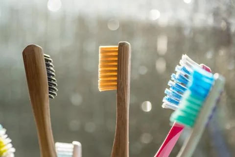Closeup view of eco-friendly bamboo toothbrush next to window in bathroom Stock-Fotos