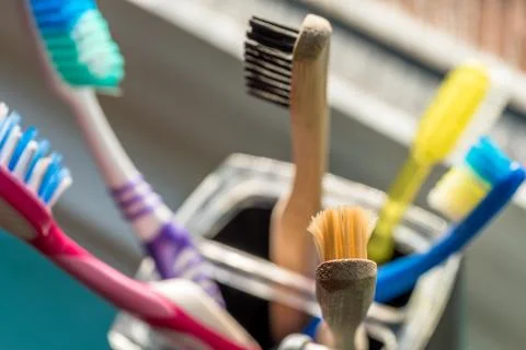 Closeup view of eco-friendly bamboo toothbrush next to window in bathroom Foto stock
