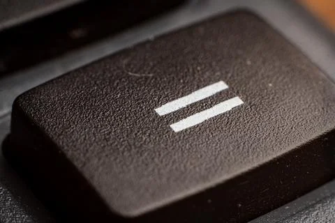 Closeup view of electronic keypad highlighting the equal sum button used for Stock Photos