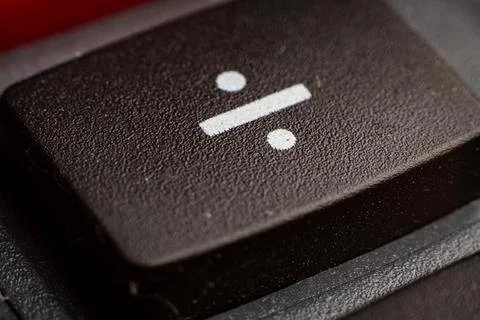 Closeup view of electronic keypad highlighting the divide button used for Stock Photos