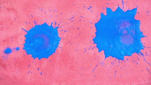 Closeup view of falling blue paints on the canvas in slow motion Stock Footage 99517961