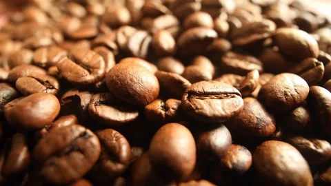 Closeup view of falling fried coffee beans in slow motion macro shooting Vídeos de archivo 98692499