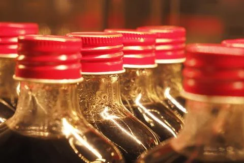 A closeup view featuring bottles that have bright red caps on them 스톡 사진