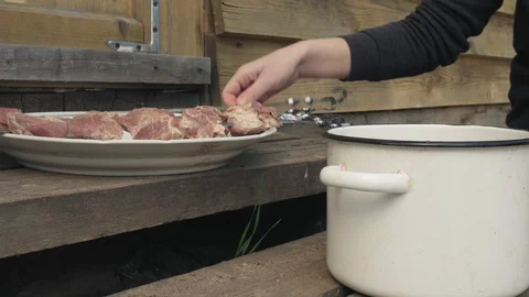 Closeup view of female hands put meat on a skewer for barbecue. Stock Footage 129317836