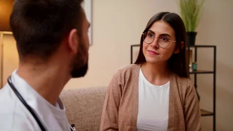 Closeup View On Female Which Talking At During Home Visit With Young Male Doctor Stock Footage 146995939
