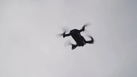 Closeup view of flying drone at overcast sky with grey clouds. Video stock 158174811