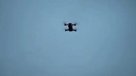 Closeup view of flying drone at overcast sky with grey clouds. Vidéo 158174999