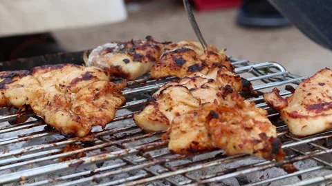 Closeup view of a fork taking pieces of BBQ from the griller in 4K Stock Footage 156330818