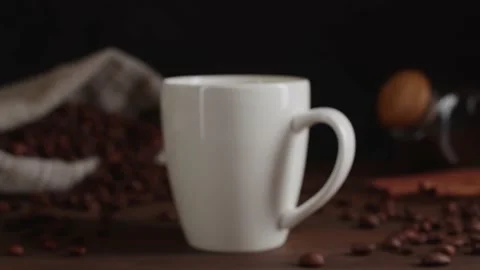 Closeup view of freshly brewed black coffee being poured into white ceramic cup Stock Footage 146861930