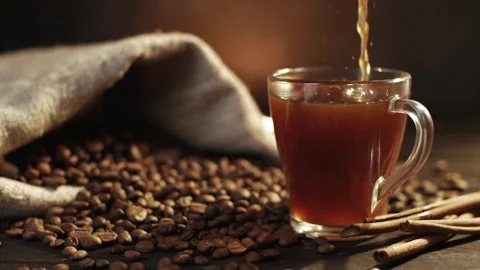Closeup view of freshly brewed fragrant black coffee being poured into glass mug Stock Footage 146869362