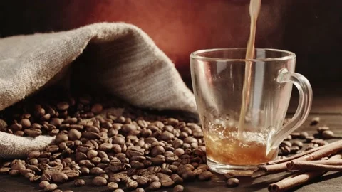 Closeup view of freshly brewed fragrant black coffee being poured into glass mug Stock Footage 146869431