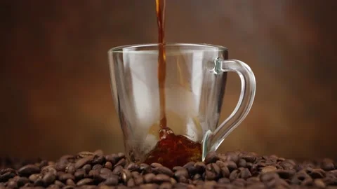Closeup view of freshly brewed fragrant black coffee being poured into glass mug Stock Footage 146921627