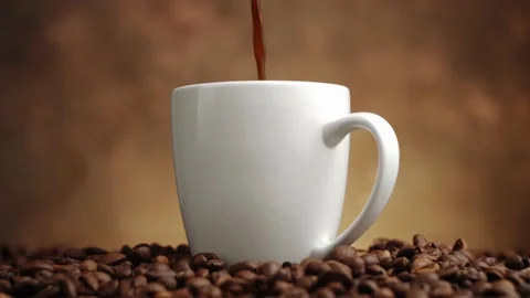 Closeup view of freshly brewed fragrant black coffee being poured into white cup Stock Footage 146921656