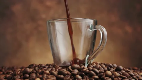 Closeup view of freshly brewed fragrant black coffee being poured into glass mug Stock Footage 146921675